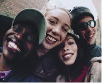 Group of young teenagers smiling at the camera.